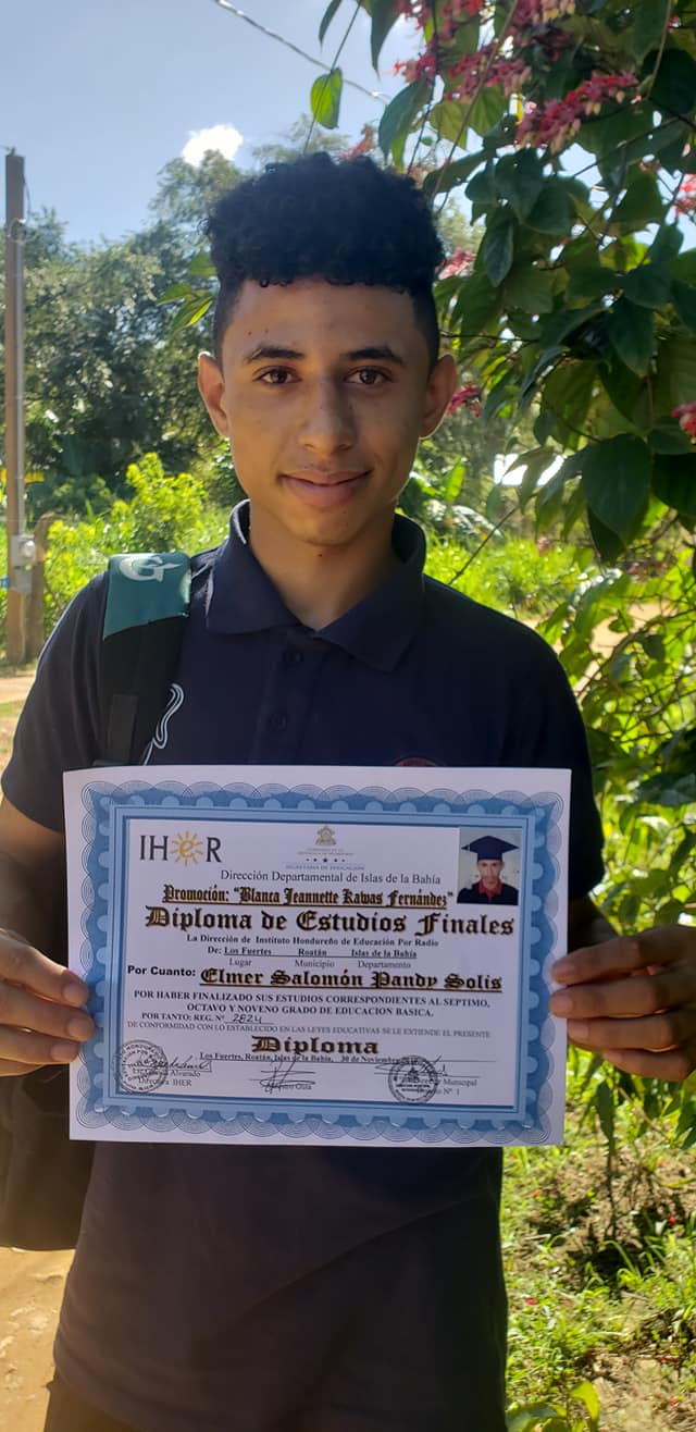 Teenage boy shows his diploma