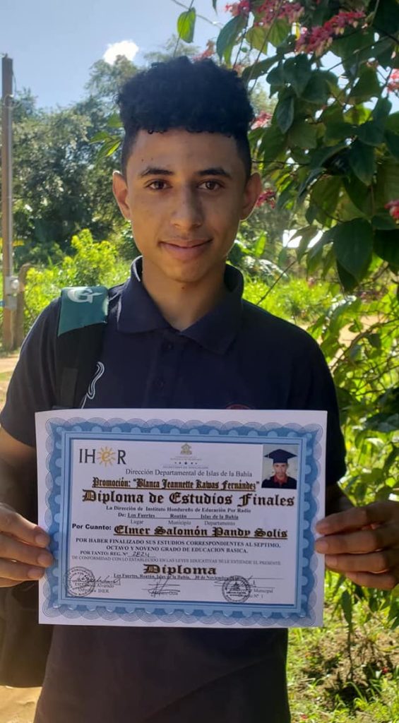 Teenage boy shows his diploma